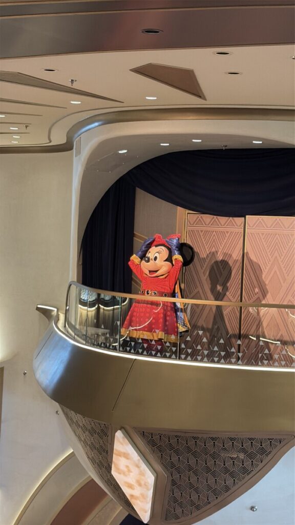 Captain Minnie greeting guests in the grand hall aboard the Disney Destiny
