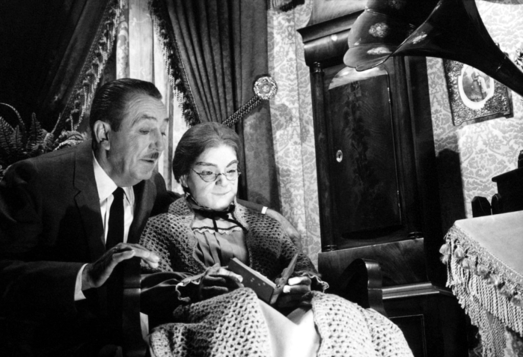 Walt Disney overlooking the grandma animatronic on Carousel of Progress
