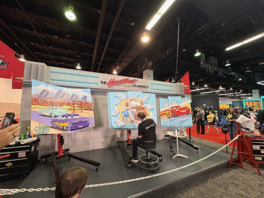 Artist painting car hoods at D23 the ultimate Disney fan event 2026